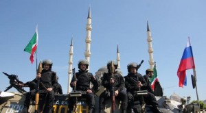 Police special forces officers ride atop