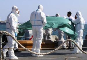 Coffins containing bodies of migrants who died are carried off a navy ship at the Sicilian harbour