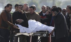 Former Egyptian President Hosni Mubarak waves to his supporters as he returns to Maadi military hospital in Cairo