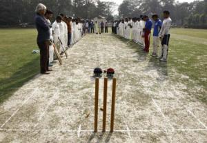 Members of two local cricket teams observe a moment of silence for Australian cricketer Phillip Hughes before their match in Kolkata