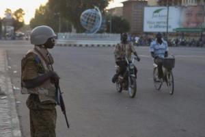 A soldier stands guard outside a building where a meeting between the military and opposition was taking place in Ouagadougou, capital of Burkina Faso