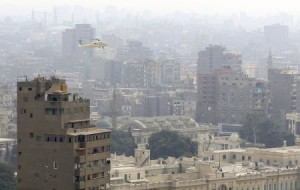 A reconnaissance military helicopter flies over Cairo