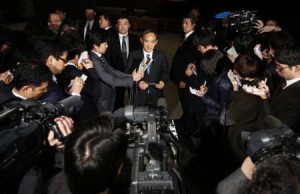 Chief Cabinet Secretary Yoshihide Suga (C) speaks to the media