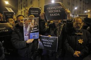 Members of the Union of French Jewish students hold posters with the first names of the victims during