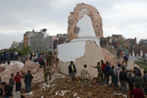 Nepalese rescue members and onlookers gather at the collapsed Darahara Tower in Kathmandu