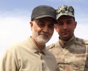 Iranian Revolutionary Guard Commander Qassem Soleimani (L) stands at the frontline during offensive operations against Islamic State militants in the town of Tal Ksaiba in Salahuddin province