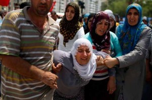 Relatives cry during the funeral of two police officers, killed in an attack by Kurdish rebels overnight,