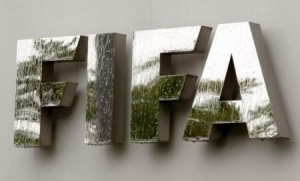 Water flows over the FIFA logo in front of the FIFA headquarters during heavy rainfall in Zurich