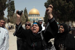 A Palestinian woman shows rubber bullets reportedly used by Israeli riot police outside the Dome of Rock at Al-Aqsa mosque in Jerusalem's Old City after clashes erupted at the compound between Palestinians and Israeli police