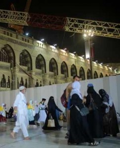 Muslim pilgrims walk past the site of a crane collapse that killed over a hundred last Friday inside the Grand Mosque in the holy city of Mecca, Saudi Arabia